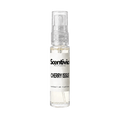 "A small, clear glass spray bottle of Scentivia Perfumes' 'Cherry issue' Extrait de Parfum featuring an off-white label and clear cap, set against a black background."