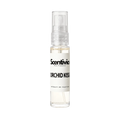 "A small, clear glass spray bottle of Scentivia Perfumes' 'Orchid Kiss' Extrait de Parfum featuring an off-white label and clear cap, set against a black background."