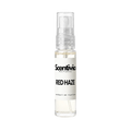 "A small, clear glass spray bottle of Scentivia Perfumes' 'Red haze' Extrait de Parfum featuring an off-white label and clear cap, set against a black background."