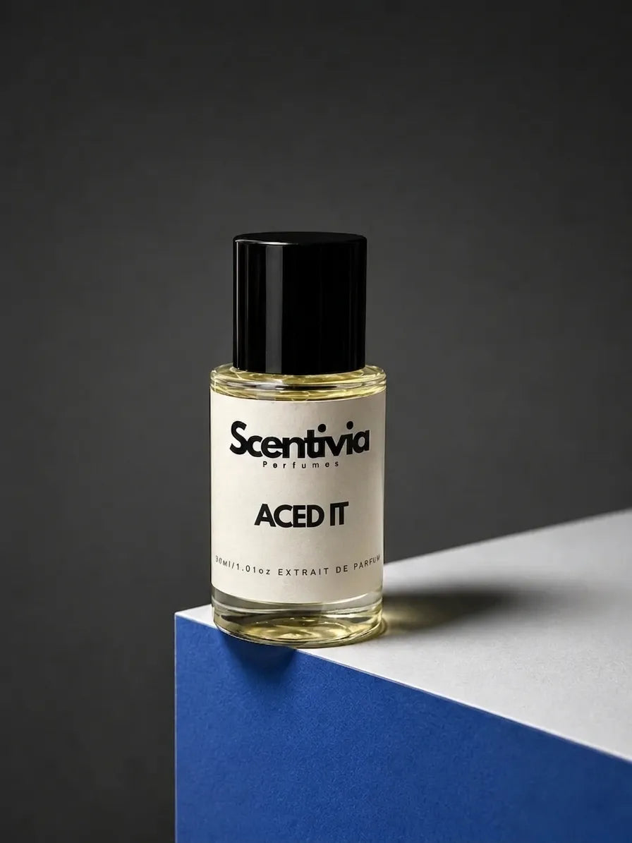 Scentivia Perfumes ACED IT  30ml extrait de parfum bottle mockup showcased on a modern blue and white geometric podium setup against a dark grey studio background.